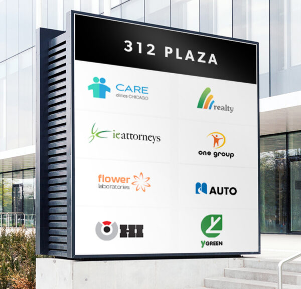 Plaza directory with business names and logos outside a corporate office